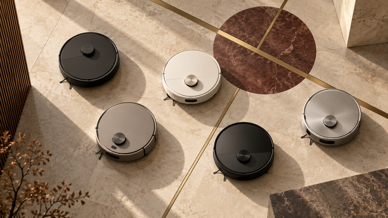 Five premium robot vacuums arranged on a warm architectural stone floor, illustrating the global robot vacuum market in Q2 2026.